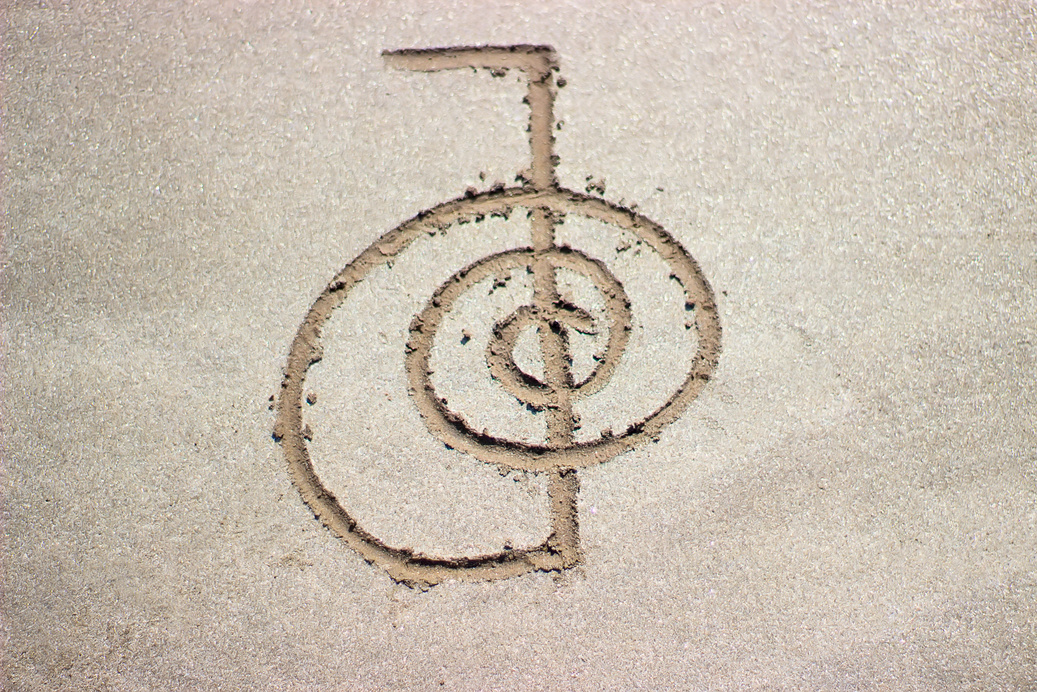 Reiki healing symbol cho ku rei on sand.