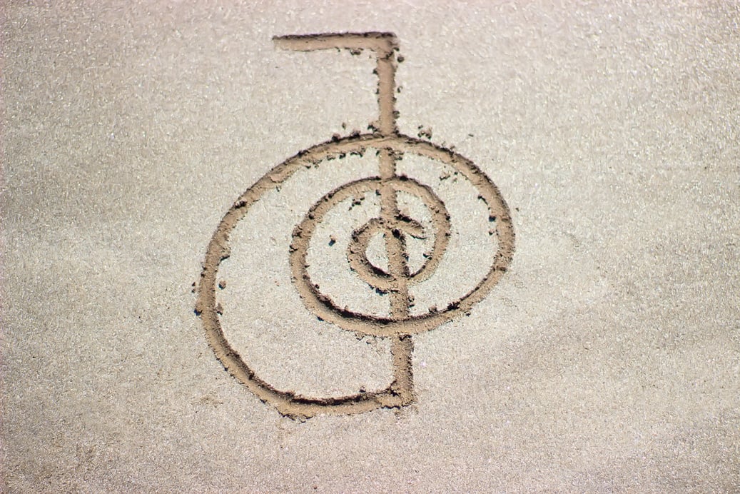 Reiki healing symbol cho ku rei on sand.